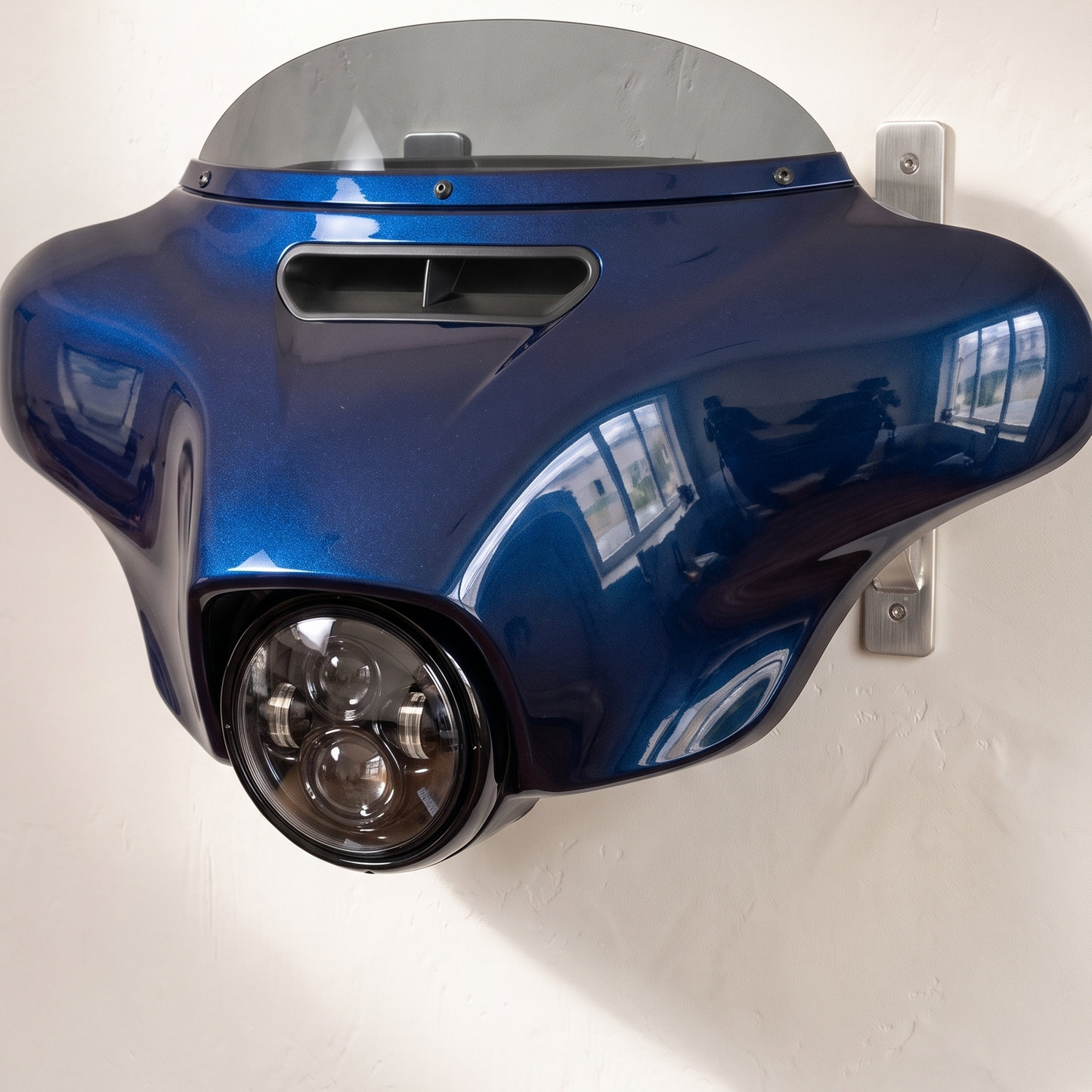 HarleyHood batwing fairing wall mount in Blue Burst on a brushed steel bracket