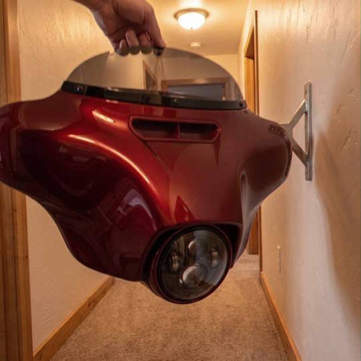 Customer photo - holding the red HarleyHood in a hallway